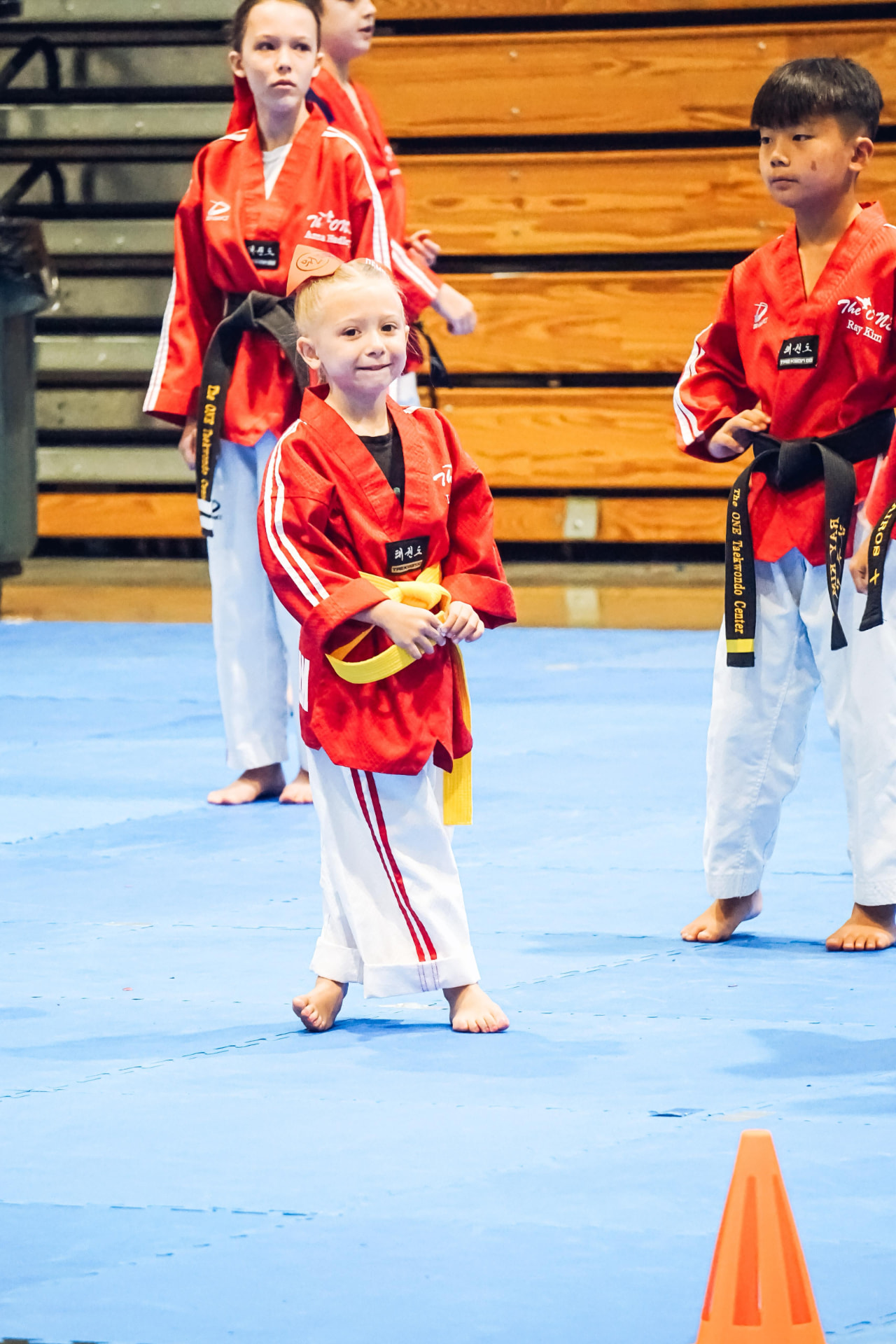 Young yellow belt student waiting on the competition mat